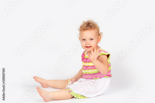 little girl with curly hair on a light background