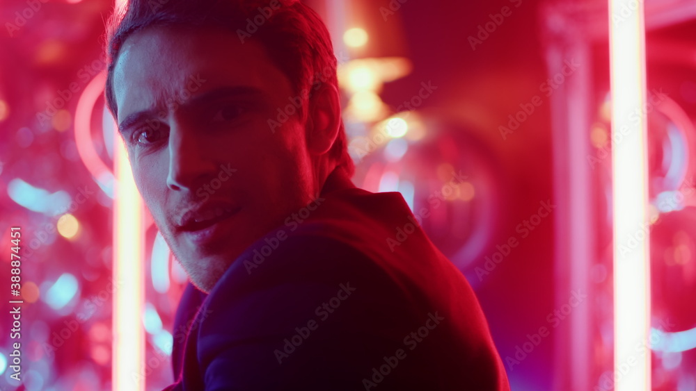 Fototapeta premium Charming man dancing at party. Attractive guy making robot moves in nightclub
