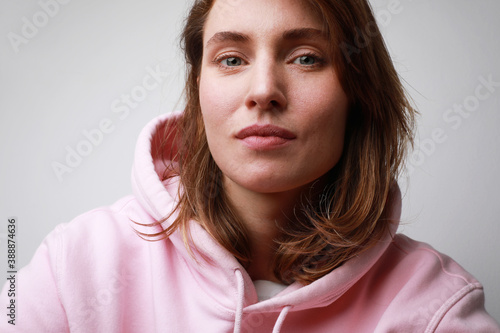 Close-up portrait of caucasian young woman, isolated on white wall.