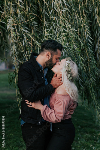 Couple Kissing under Willow Tree photo