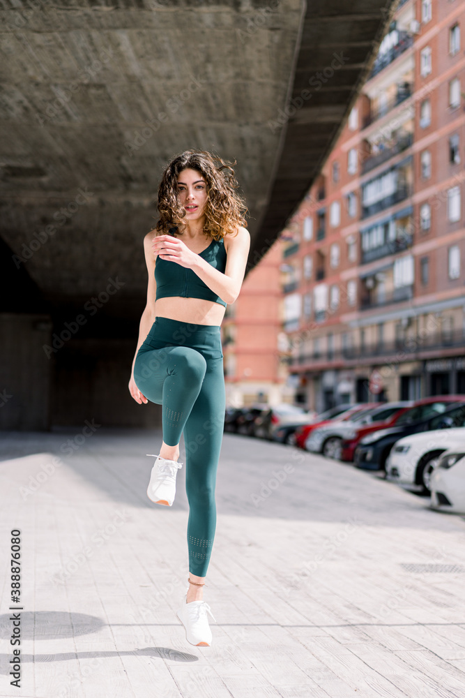 Sportswoman doing stretching exercise in city Sportswoman doing stretching exercise in city