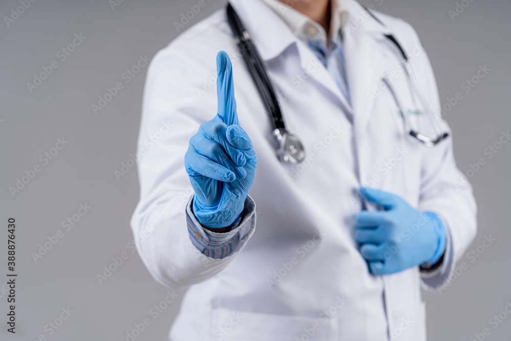 Selective focus on doctor`s hands in blue medical gloves. Cropped photo of a medic in scrubs. Healthcare concept. Selective focus on doctor`s hands in blue medical gloves. Cropped photo of a medic in scrubs. Healthcare concept.