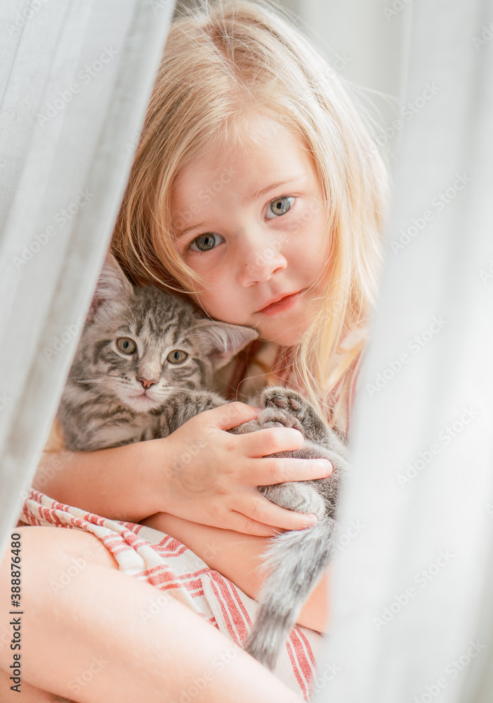 little girl holds tiny kitten little girl holds tiny kitten