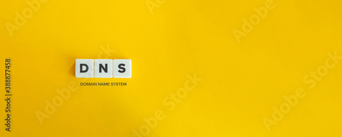DNS (Domain Name System) banner and concept. Block letters on bright yellow orange background. Minimal aesthetics.