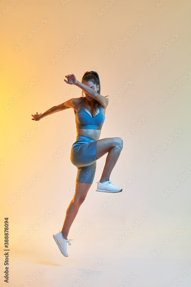 Fit lady jumping during training Fit lady jumping during training