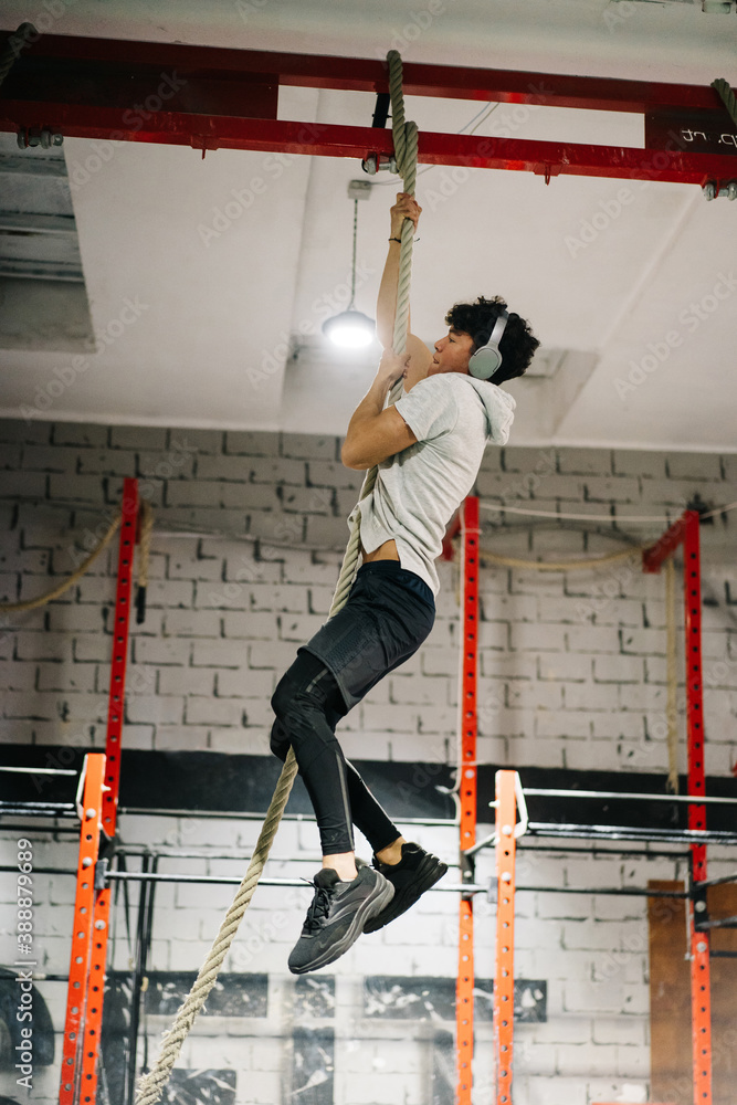 Sportsman climbing up a rope Sportsman climbing up a rope