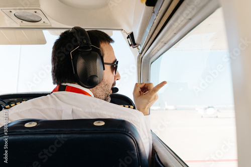 Unrecognizable pilots during check list before flight photo