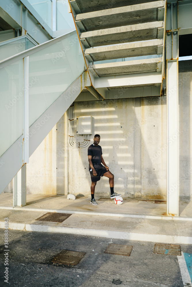 Sportsman with soccer ball looking at camera Sportsman with soccer ball looking at camera