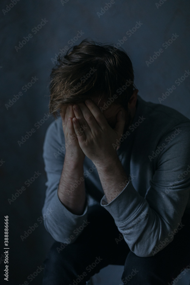 portraits of a guy in a depressed mood at home by a window in a dim light portraits of a guy in a depressed mood at home by a window in a dim light