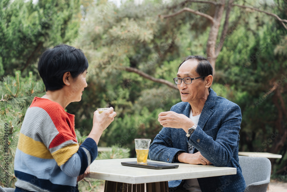 middle-aged couple drinking tea outside middle-aged couple drinking tea outside