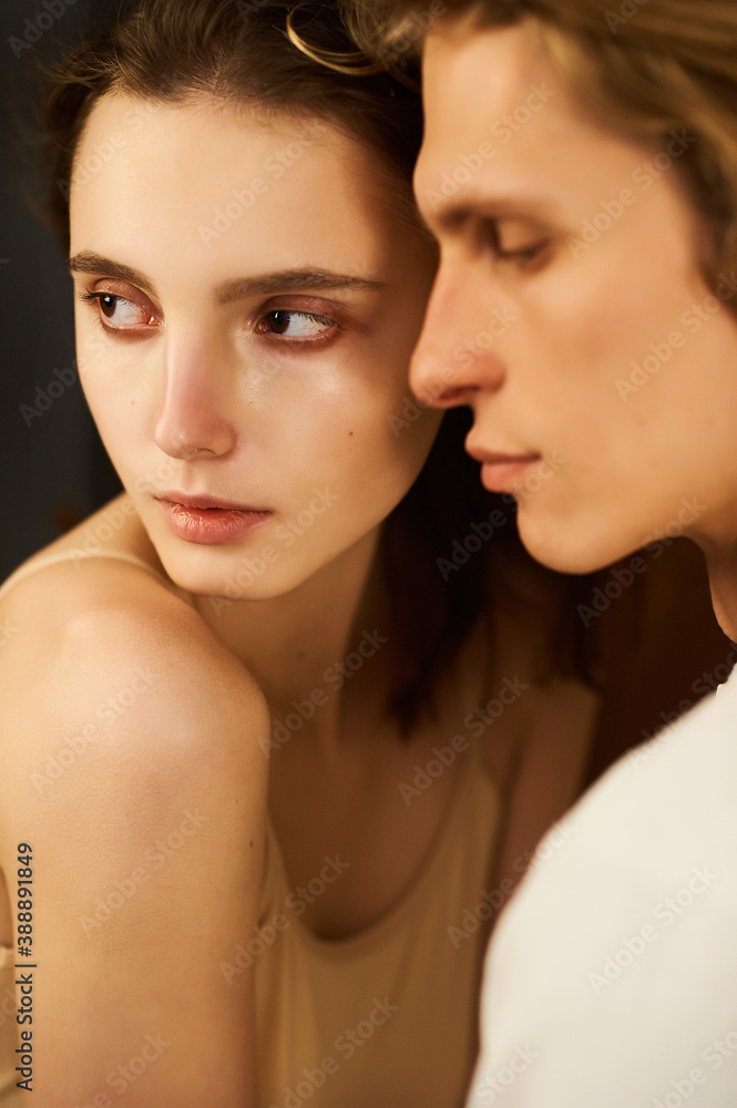 a portrait of young beautiful woman and man on a beige background a portrait of young beautiful woman and man on a beige background