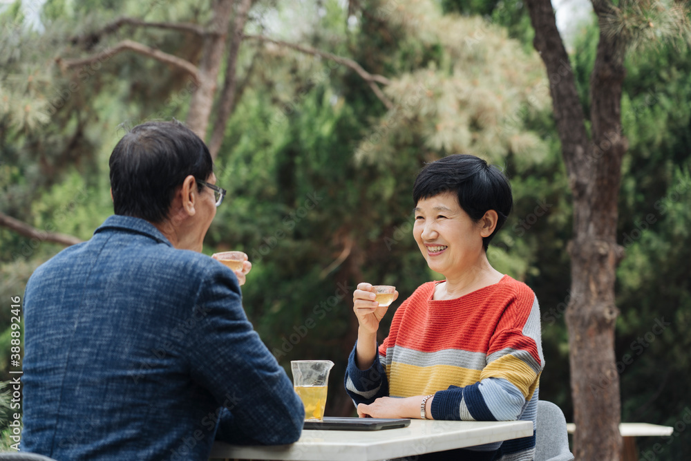 middle-aged couple drinking tea outside middle-aged couple drinking tea outside