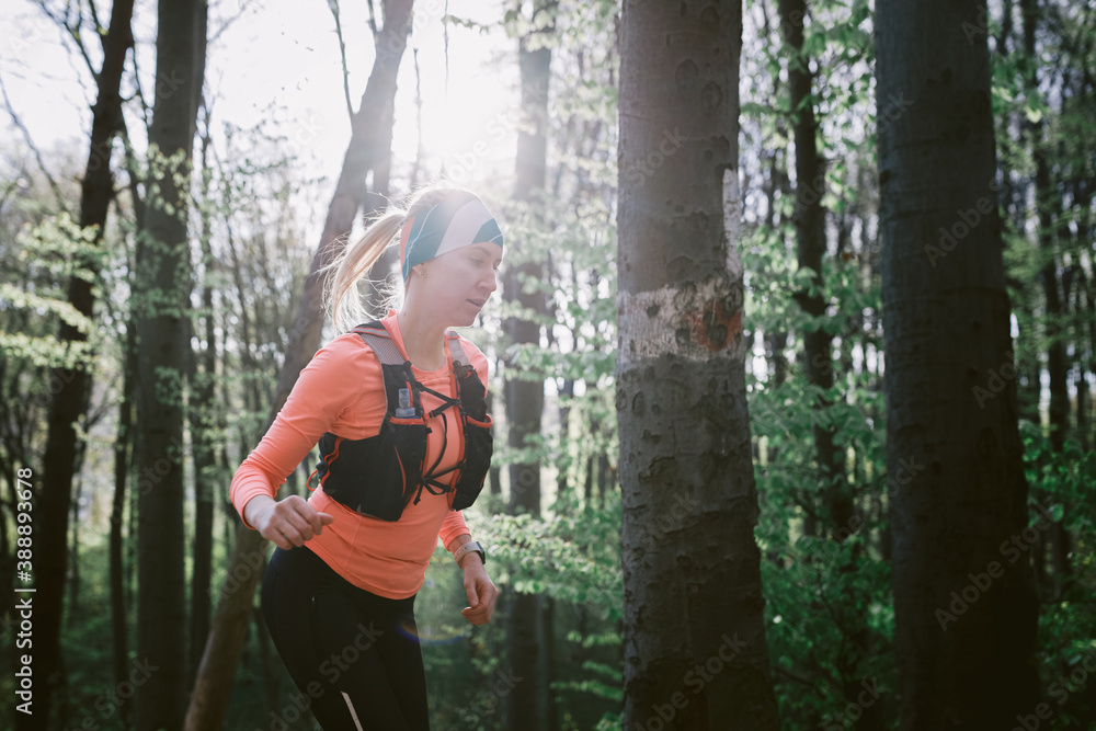 Professional runner jogging in forest Professional runner jogging in forest