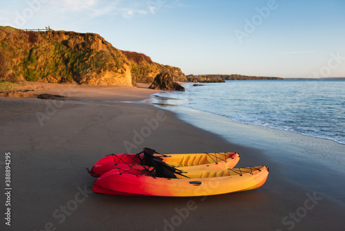Kayaks at the beach during sunrise. photo