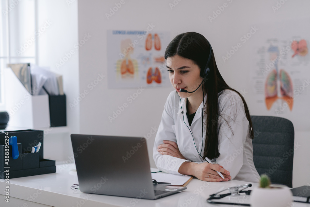 Doctor having online session in clinic Doctor having online session in clinic