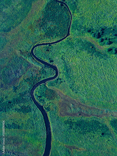 Aerial view of river winding along green landscape of Krabbe Peninsula