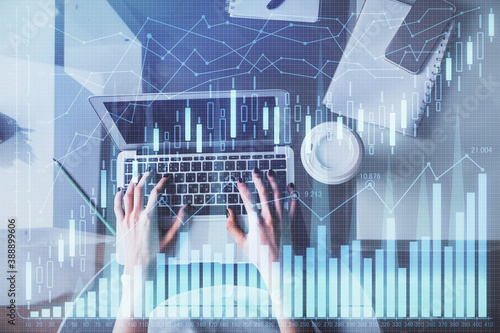 Double exposure of woman hands working on computer and forex chart hologram drawing. Top View. Financial analysis concept. © peshkova