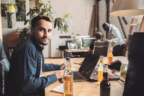 Portrait of entrepreneur working on laptop at workplace photo