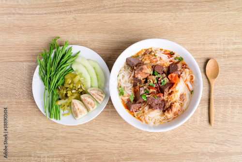 Northern Thai food (Kanom Jeen Nam Ngeaw), Rice noodles spicy soup with pork and pork blood eating with fresh vegetables, Top view photo