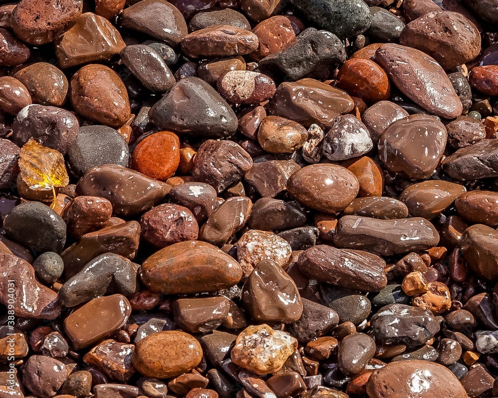 Colorful wet beach stones washing in the waves on the shore of Lake Superior Colorful wet beach stones washing in the waves on the shore of Lake Superior