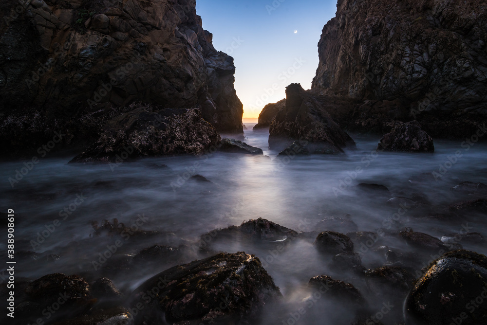 Long exposure image of the rocks in the famous Pfeiffer Beach as the moon sets.