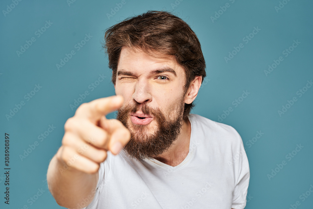 emotional man gesturing with hands lifestyle fun white t-shirt blue isolated stock emotional man gesturing with hands lifestyle fun white t-shirt blue isolated stock