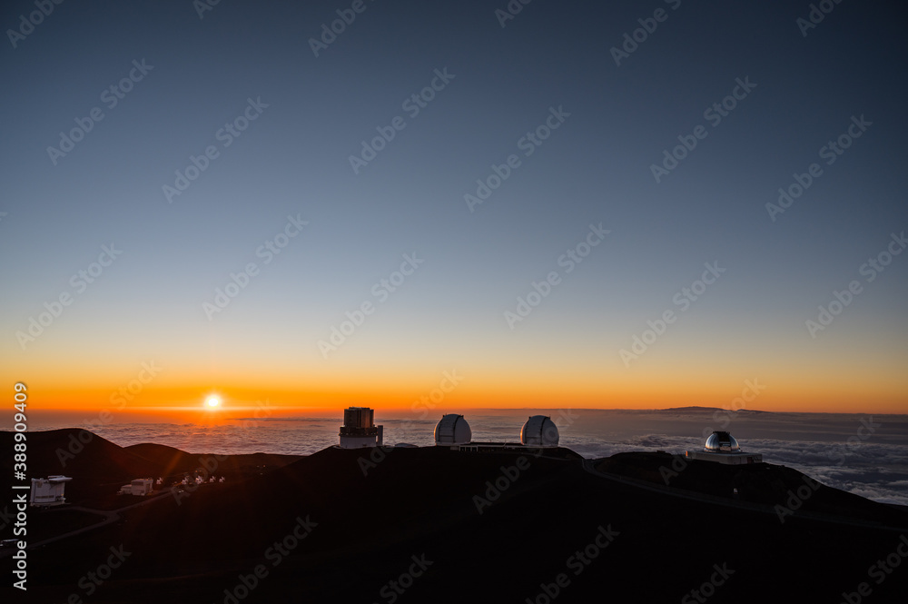 Observatories and the Haleakala volcano seen from the top of the Mauna Kea volcano right before sunset. Big Island, Hawaii.
