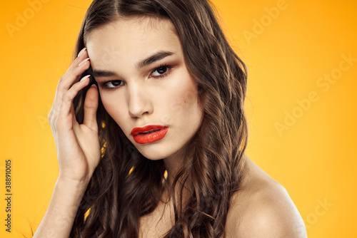 Woman with bare shoulders red cropped lips charm yellow background