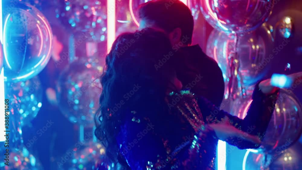Joyful male and female enjoying party in club. Couple moving in nightclub Joyful male and female enjoying party in club. Couple moving in nightclub