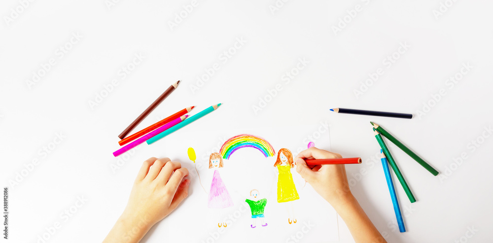 Banner with unrecognizable caucasian boy drawing by coloured pencils his LGBT family. Two mums, son and rainbow. Top view. Copy space on top. Banner with unrecognizable caucasian boy drawing by coloured pencils his LGBT family. Two mums, son and rainbow. Top view. Copy space on top.