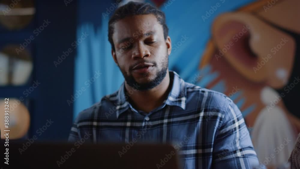 Upset afro man throwing paper in coworking. Man crumpling document in office Upset afro man throwing paper in coworking. Man crumpling document in office