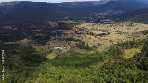 Farm Houses At Numinbah Valley - Lush Green Mountain View From Rosin's Lookout - Beechmont, QLD, Australia. - aerial tilt-down photo