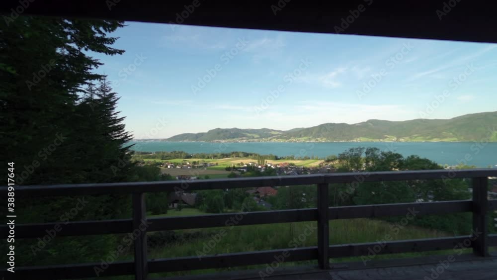 Dolly shot over fence towards beautiful sunny Alps mountains with scenic blue lake Dolly shot over fence towards beautiful sunny Alps mountains with scenic blue lake