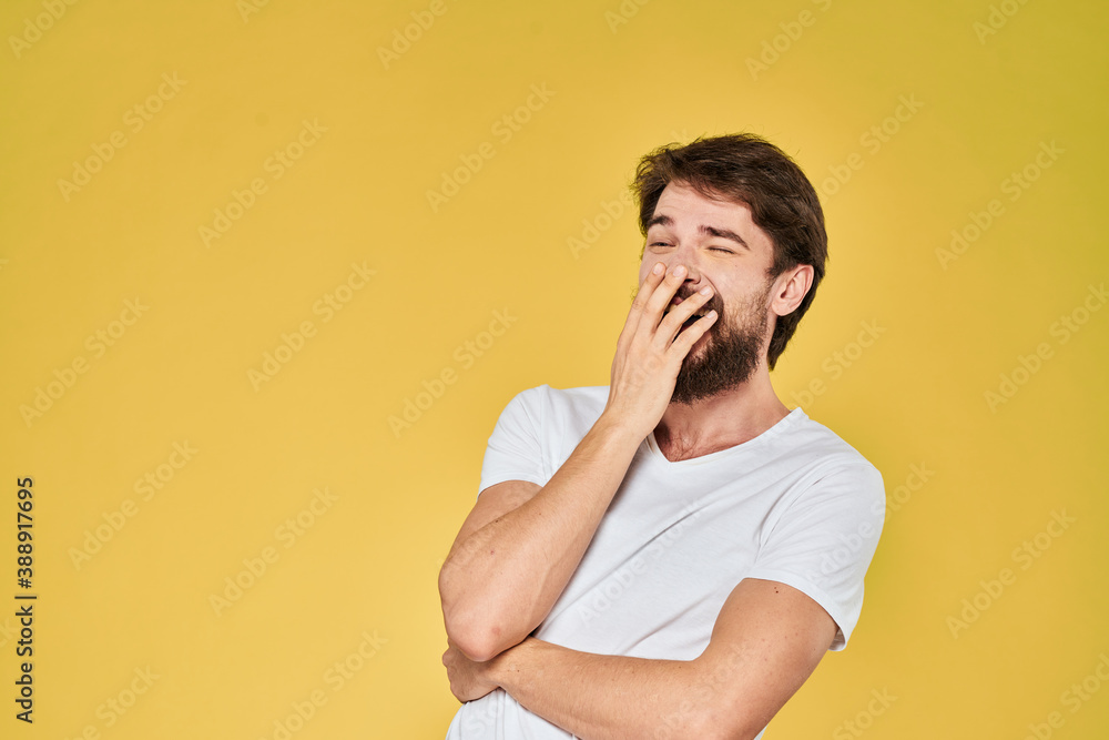 Bearded man white t-shirt emotions gestures with hands fun yellow background Bearded man white t-shirt emotions gestures with hands fun yellow background