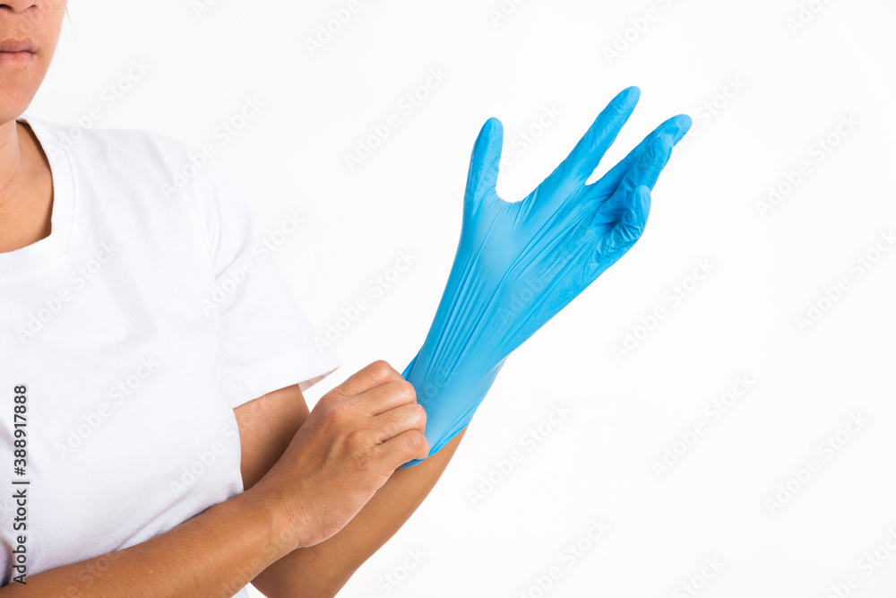 Woman wearing and putting hand to blue rubber latex glove for doctor, studio shot isolated on white background, Hospital medical safety concept