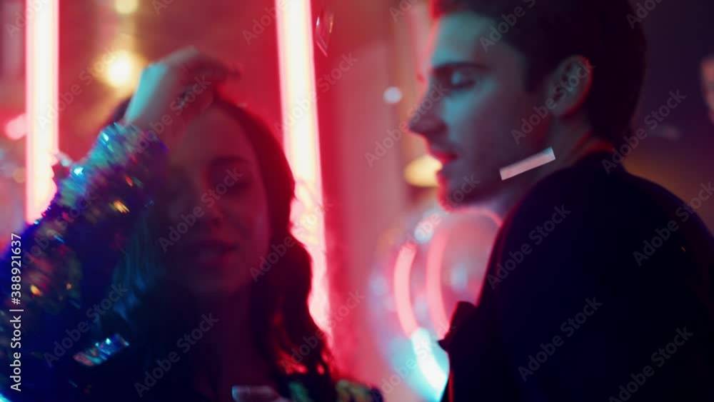 Fancy couple dancing in nightclub. Girl and guy hugging at disco party Fancy couple dancing in nightclub. Girl and guy hugging at disco party