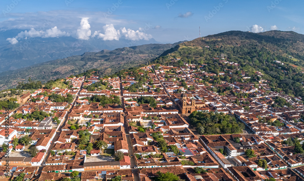 Aerial view panorama of historic town Barichara, Colombia with white cloud covered mountain ridge in background