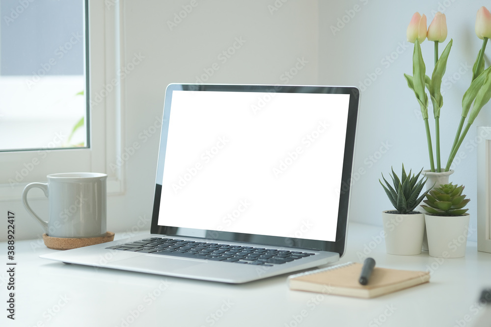 Front view of minimal desk with white blank screen laptop monitor for product display montage. Front view of minimal desk with white blank screen laptop monitor for product display montage.