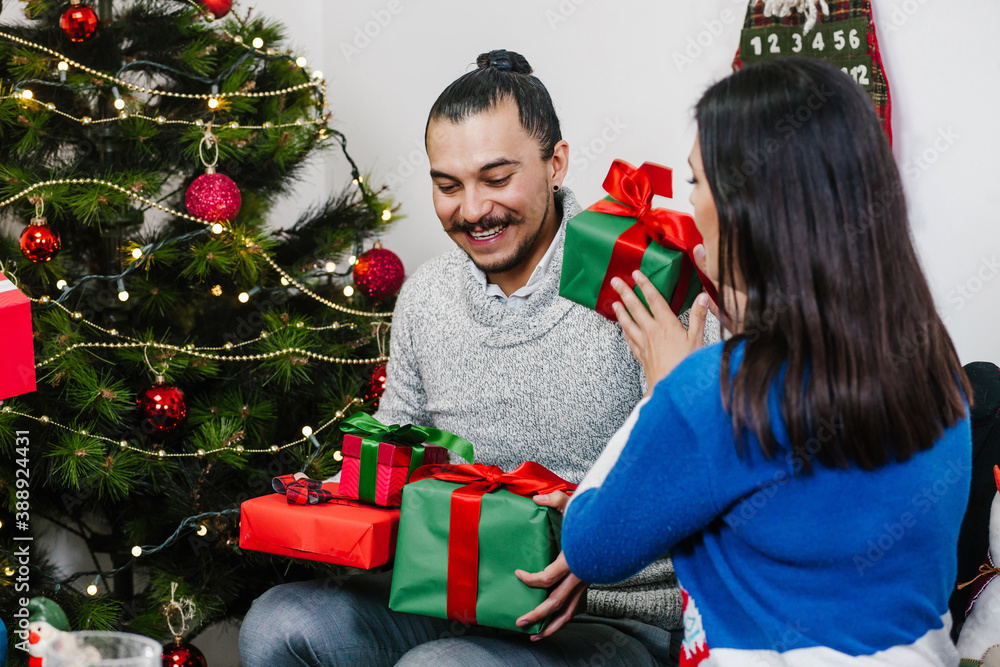 Mexican man surprised enjoying Christmas celebration while exchanging gifts on Mexico city Mexican man surprised enjoying Christmas celebration while exchanging gifts on Mexico city