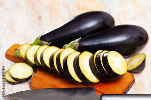 Organic eggplant on wooden cutting board. Healthy nutrition concept