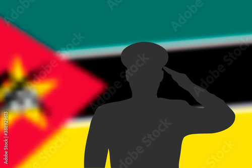 Solder silhouette on blur background with Mozambique flag.