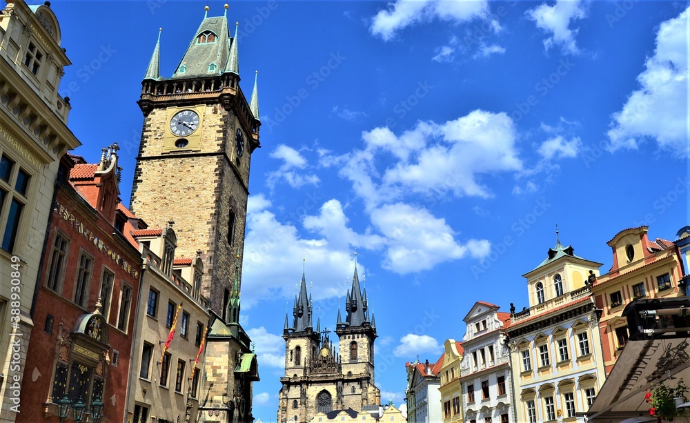 Prague and Czech Republic during sunny day. Top of the ancient buildings in Prague together with blue sky and white cloud background.