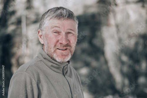 Portrait of an unshaven attractive and happy middle-aged man outdoors. People and lifestyle concept. Copy space.