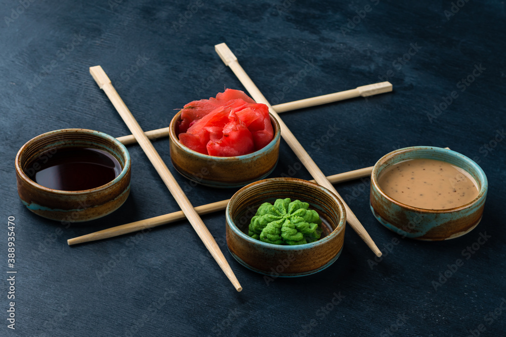 soy sauce, wasabi and ginger with sticks in the shape of checkers soy sauce, wasabi and ginger with sticks in the shape of checkers