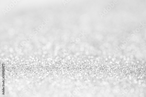 blurred abstract sparkling silver bokeh background. festive decoration for website banner and card concept. soft focus