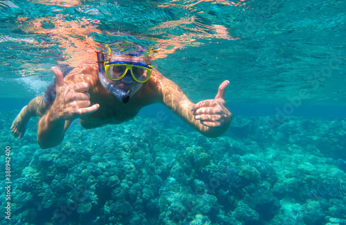 Underwater shot. Man diving with scuba in a tropical sea. Travel lifestyle, outdoor water sport adventure, swimming lessons on summer beach vacation