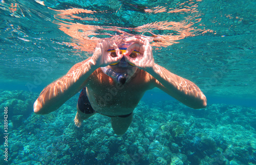 Underwater shot. Man diving with scuba in a tropical sea. Travel lifestyle, outdoor water sport adventure, swimming lessons on summer beach vacation