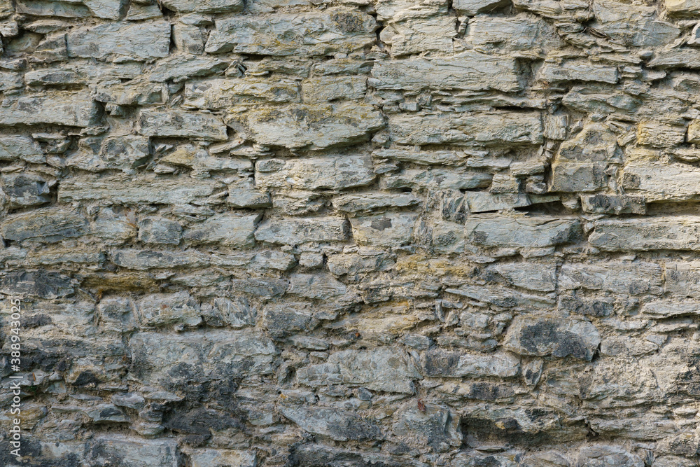 Fragment of a gray stone wall. Fragment of a gray stone wall.