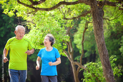 Asian Senior Couple jogging in the nature park