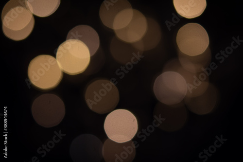 abstract blurred tungsten light bokeh light in the dark night as festive background